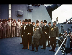 'Surrender of Japan, Tokyo Bay, 2 September 1945: Representatives of the Empire of Japan on board USS Missouri (BB-63) during the surrender ceremonies. Standing in front are: Foreign Minister Mamoru Shigemitsu (wearing top hat) and General Yoshijiro Umezu, Chief of the Army General Staff. Behind them are three representatives each of the Foreign Ministry, 